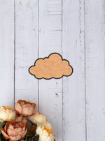 Unpainted MDF cloud-shaped DIY craft cutout with rounded edges, isolated on wooden background 