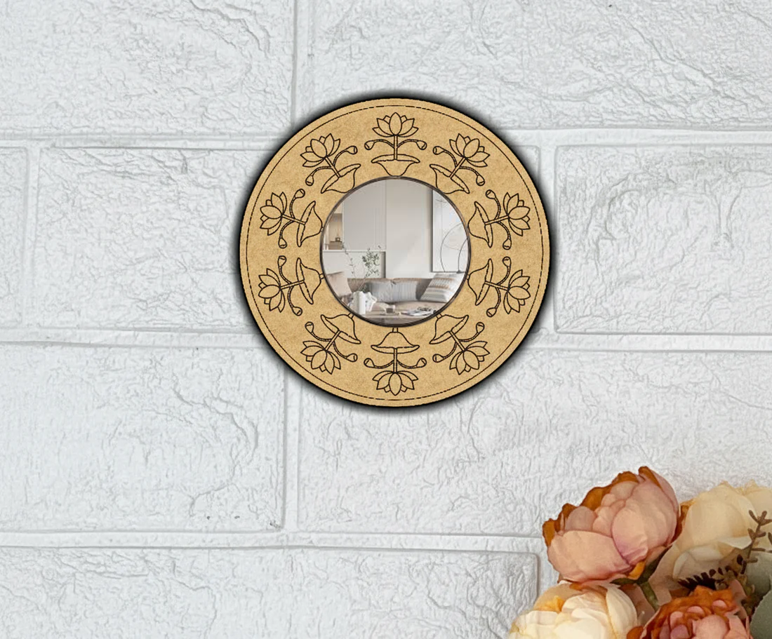 Round wall mirror with floral patterns on a textured white wall.