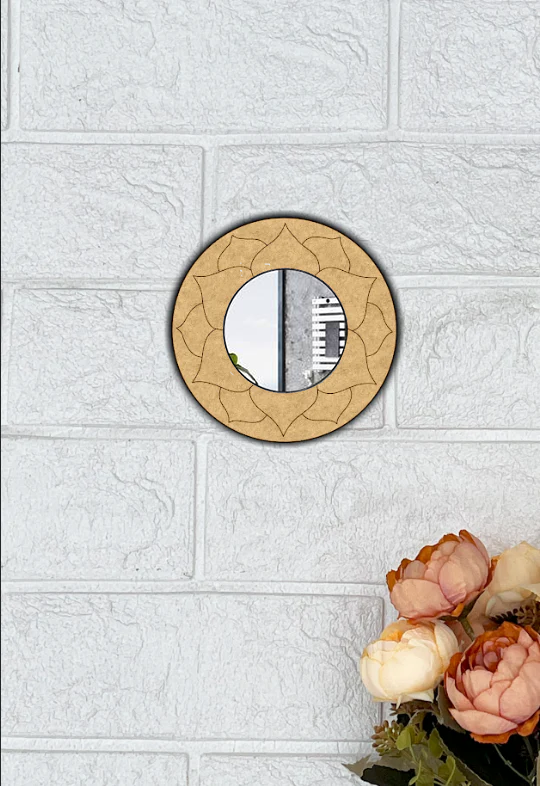 Round mdf DIY wall mirror with floral design on a textured white wall.