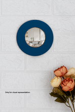 Round DIY Wall mirror with blue frame on a textured white wall with flowers at the bottom.