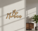 Unpainted MDF Be Human quote DIY cutout for wall decor and craft projects, mounted on wall