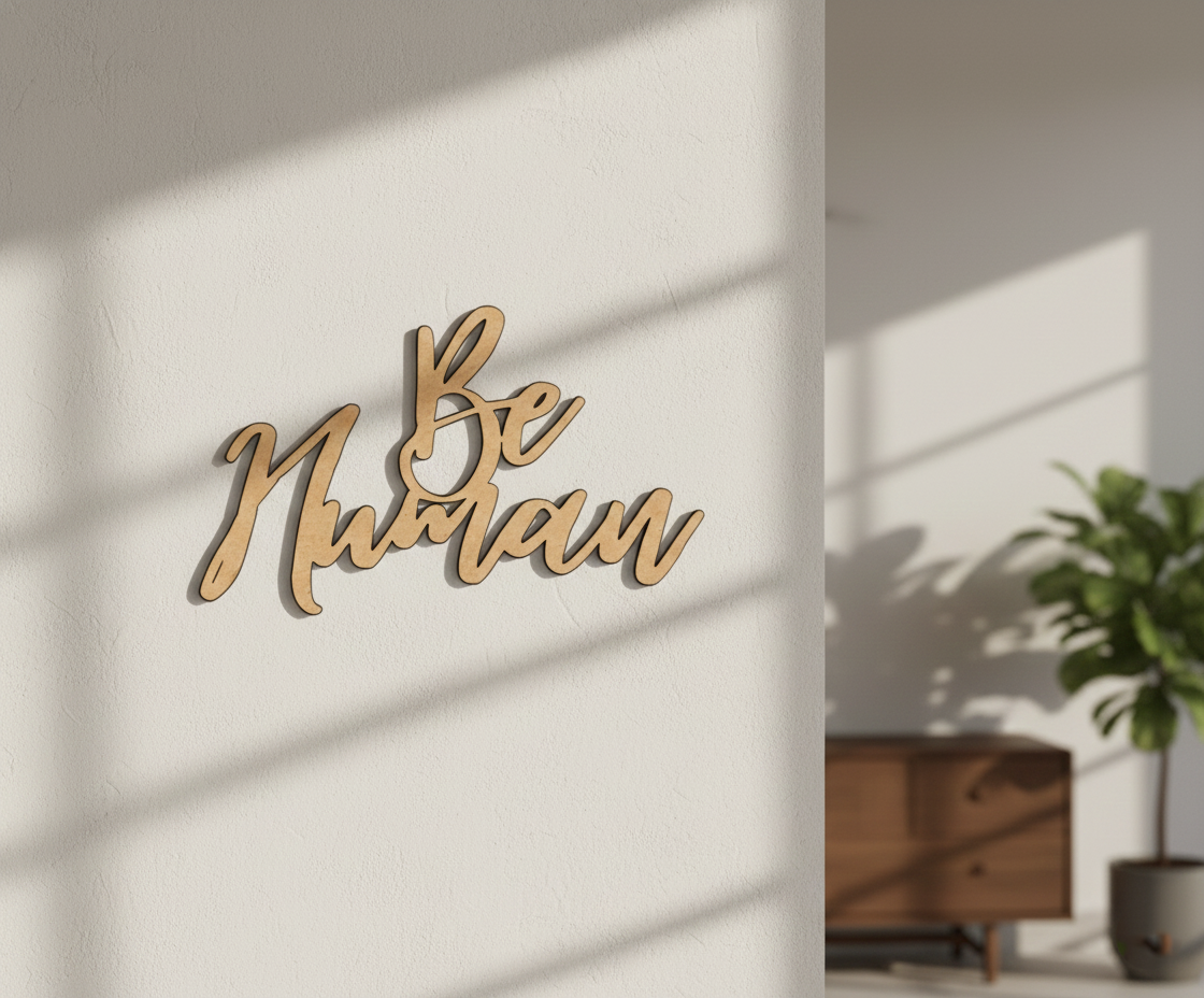 Unpainted MDF Be Human quote DIY cutout for wall decor and craft projects, mounted on wall