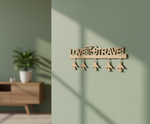 Unpainted MDF Love To Travel quote laser cut DIY wall decor key holder with airplane charms, mounted on wall