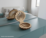 Wooden shell-shaped MDF DIY Jewellery Box on a teal surface with a blurred bedroom background