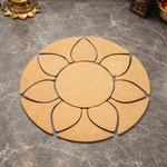 Unpainted MDF round rangoli base with layered petal shapes arranged around a central circle placed on a marble floor
