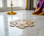 Unpainted MDF floral leaf rangoli cutout set with central round base surrounded by leaf and flower shapes in a circular pattern placed on marble floor