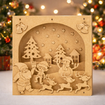 DIY MDF 3D Christmas shadow box scene with Santa, elf, reindeer, snowman and village, layered craft decor base standing on table 