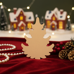 DIY MDF Christmas tree cutout for painting and holiday decor standing on decorated table 