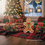 DIY MDF gingerbread man coloured  cutout with engraved face standing on decorated table (visual representation).