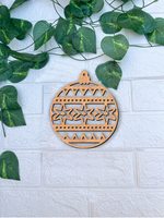 Laser-cut DIY MDF Christmas bauble cutout with star pattern, ornament blank for painting and festive décor mount on white brick wall