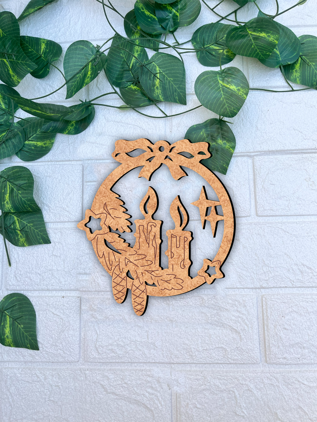 Laser-cut DIY MDF candle wreath ornament cutout with bow, stars and pinecones, Christmas craft mount on white wall