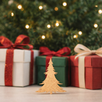 Unpainted DIY MDF Christmas tree cutout standing on a table, with festive gift boxes and blurred Christmas lights in the background.