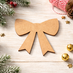 Blank DIY MDF ribbon bow cutout for painting, Christmas gift topper show on table 