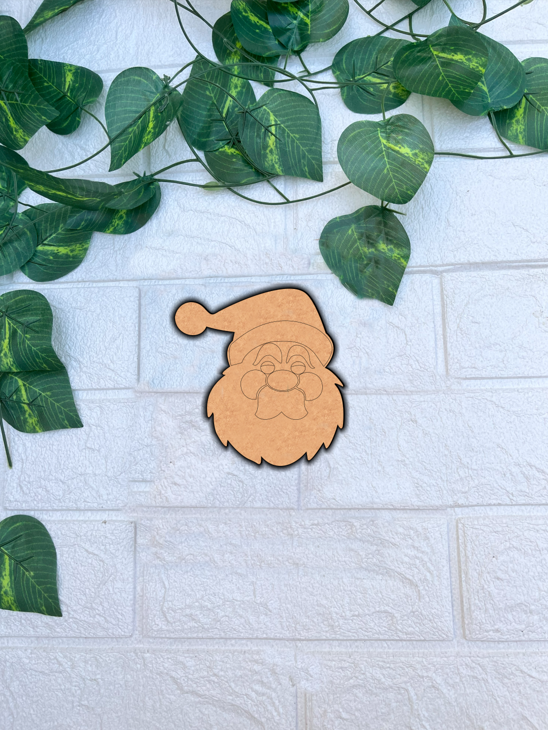 Blank DIY MDF Santa face cutout with hat and beard outline for painting mount on white wall