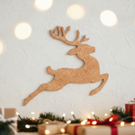 Unpainted MDF reindeer silhouette cutout in a leaping pose with antlers, displayed on white wall