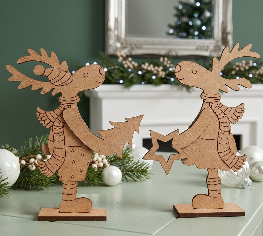 Two mdf reindeer decorations on a surface with festive background
