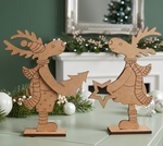 Two mdf reindeer decorations on a surface with festive background
