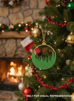 Glitter-finish MDF Christmas bauble ornament with Santa sleigh and reindeer cutout, hanging on a decorated Christmas tree near a warm fireplace.