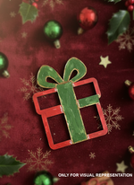 Hand-painted MDF Christmas gift box cutout in red and green, displayed on a festive red holiday background with ornaments and snowflake accents.