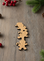 Unpainted MDF stacked Christmas character cutout red baubles and warm fairy lights.