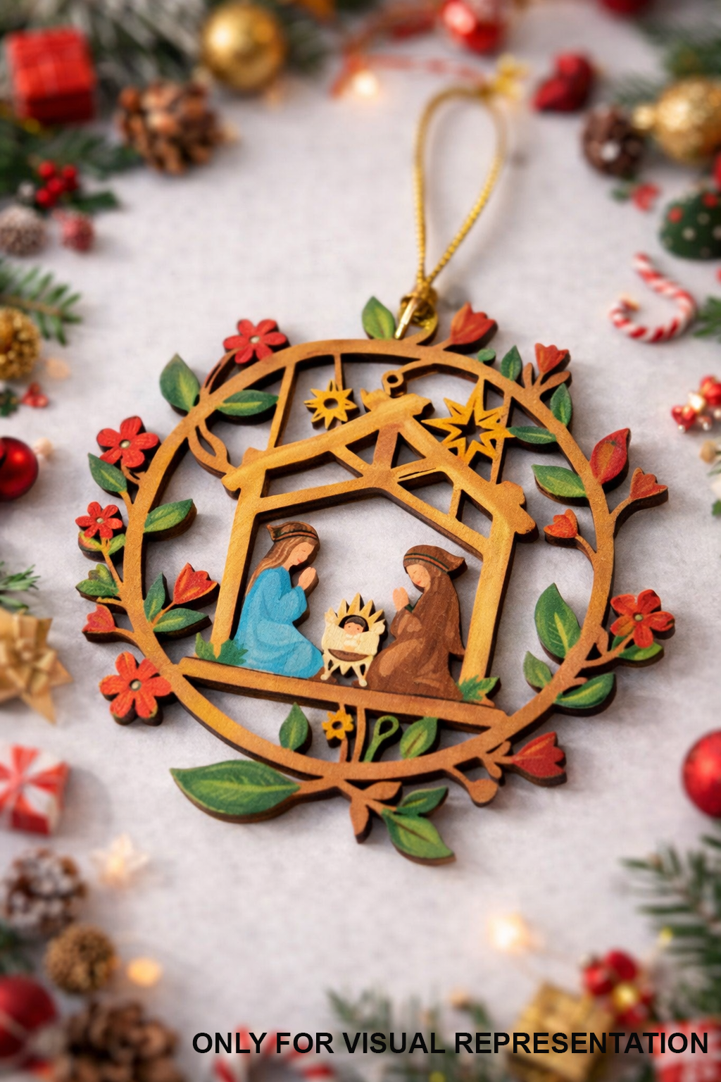 Hand-painted layered MDF nativity Christmas ornament with Mary, Joseph, and baby Jesus inside a wreath frame, placed on a festive holiday background with decorations and lights.
