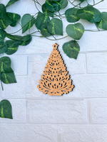 DIY MDF Christmas tree cutout for Christmas craft mounted on white brick wall