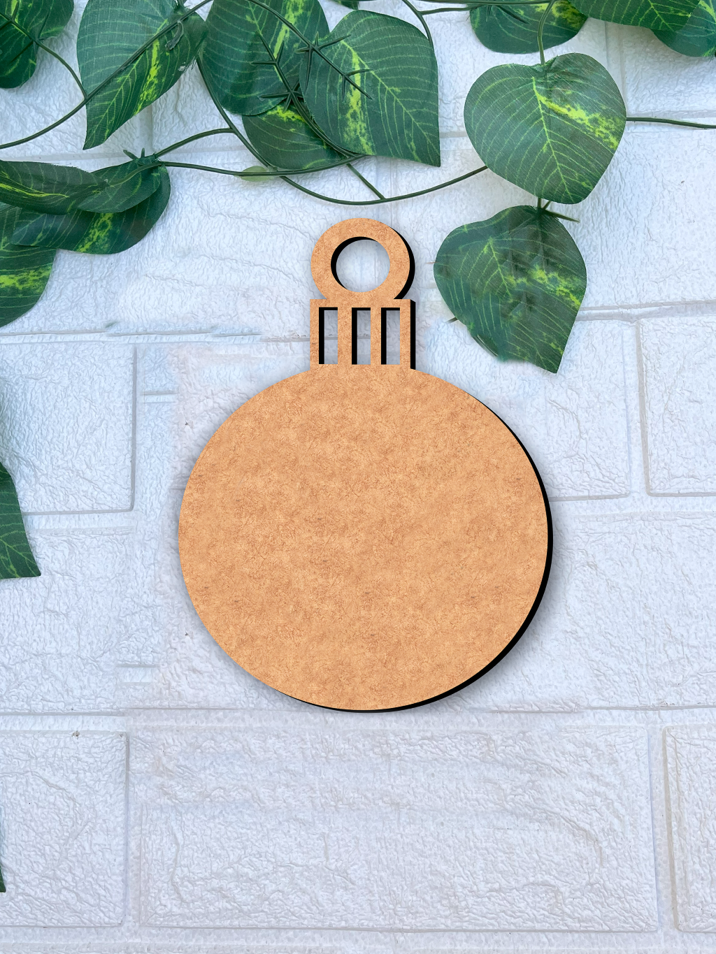DIY MDF blank Christmas bauble cutout ornament for craft mounted on white brick wall