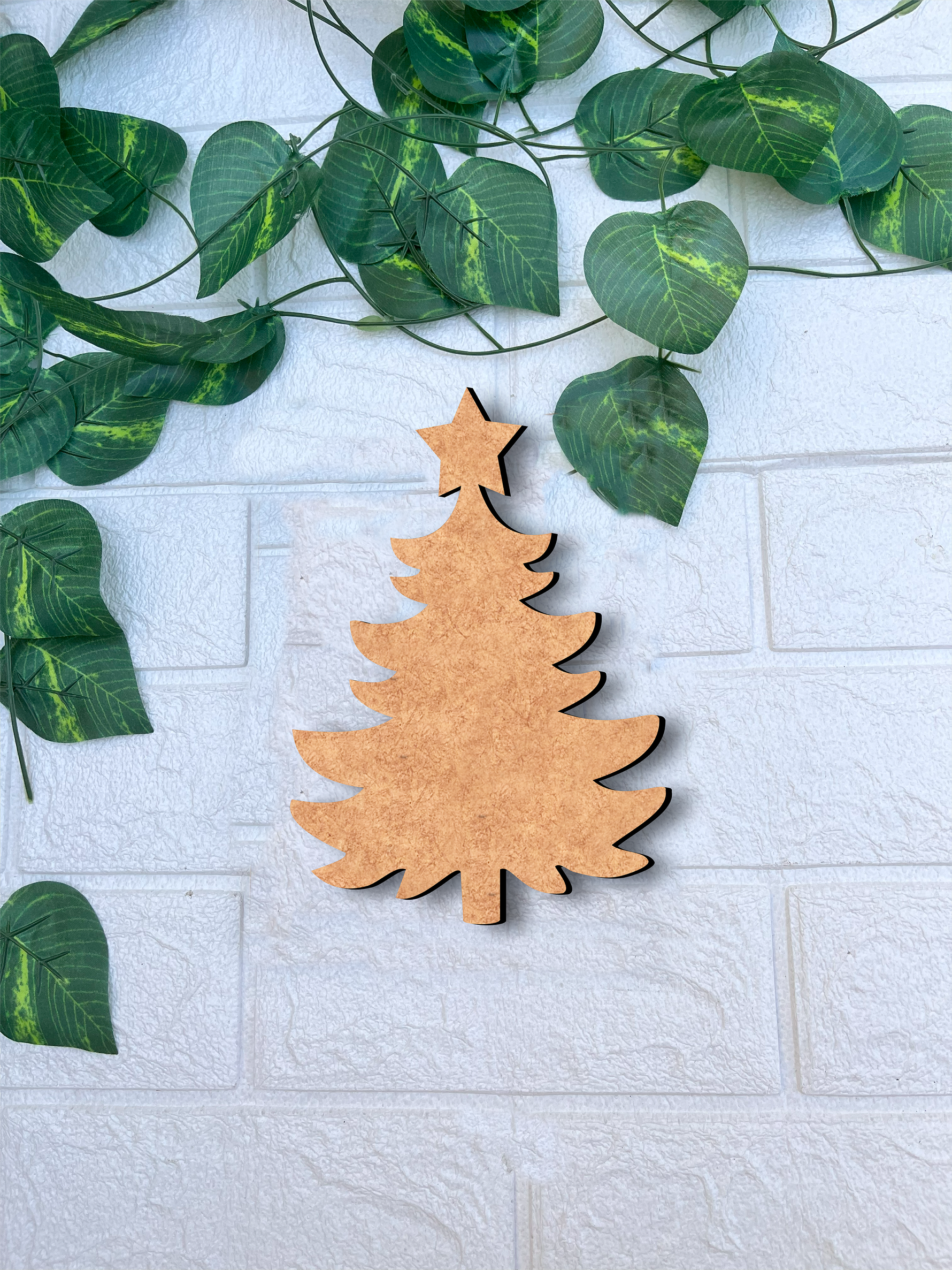 DIY MDF Christmas tree cutout with star for Christmas craft and painting mounted white brick wall