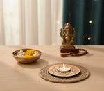 Decorative setup with a candle, bowl of flowers, and small statue on a wooden surface with mdf tealight candle holder.