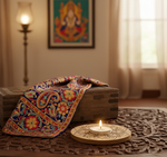 Decorative setting with a colorful paisley blanket, lit candle, and framed artwork in a room mdf tealight candle holder.