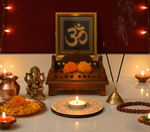 Decorative setup with candles, flowers, and a statue on a table with mdf tea light candle holder in the centre.