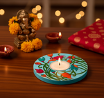 Decorative candle holder with floral design on a wooden table with Diwali decorations with handpainted mdf tea light candle holder.