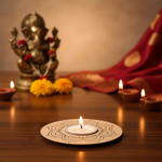 Decorative setup with a lit candle, flowers, and a statue on a wooden surface with MDf tea light candle holder on it.