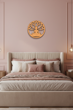 MDF DIY wall art of a meditating figure on a pink wall above a bed with pink and beige bedding.