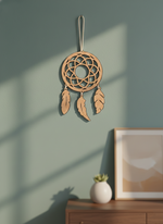 MDF DIY  dreamcatcher hanging on a green wall with a framed picture and small plant below.