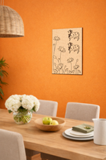 Dining room with an orange wall, wooden table, chairs, and a decorative MDF DIY  wall art piece.
