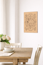 MDF DIY  wall art above a dining table with flowers and a newspaper.