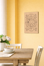 Dining room with a wooden table and chairs, and a decorative MDF DIY  wall art piece on a yellow wall.