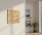 Decorative MDF DIY wall art with abstract design on a light gray wall in a room with a plant and framed pictures.