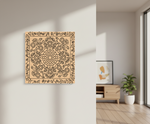 Decorative MDF DIY wall art with intricate patterns on a plain wall, next to a room with a wooden cabinet and plant.