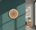 Decorative circular MDF DIY wall art with geometric design on a teal wall.