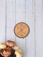 MDF Bordered Pre Marked Twin Fish Base round board with engraved fish design hanging on a wooden wall