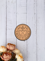 Engraved MDF round base with peacock and lotus design for DIY wall decor and painting projects hanging on a wooden wall