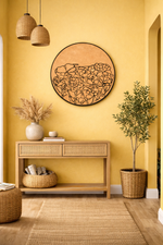 Nest living room with wooden console table, MDF wall art, and plants against a yellow wall.