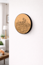 Round MDF DIY wall art with floral design on a white wall