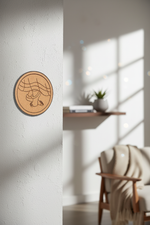MDF feet design wall décor on light wall above wooden cabinet and books.