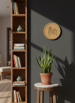 MDF cow-engraved round wall plate on blue accent wall with indoor plants and armchair.
