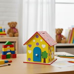 Brightly painted yellow house-shaped piggy bank with hearts and tree