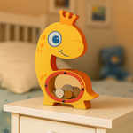 DIY MDF dinosaur-shaped money box with a crown on a wooden surface in a room setting.