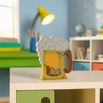 Children's room with a decorative DIY MDF mug shaped money bank on a table.